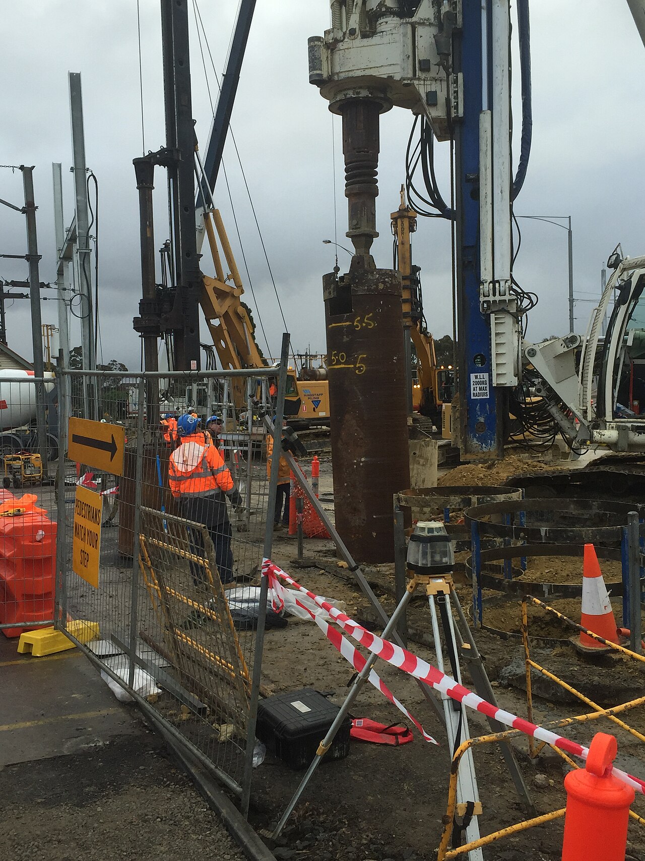Civil construction site with safety barriers, equipment and workers