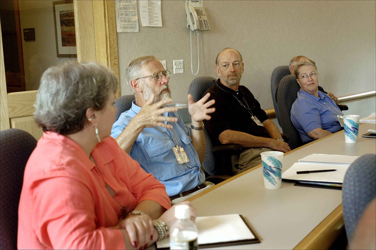 People discussing work around a meeting table